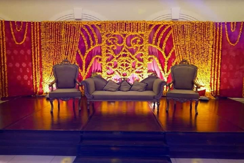 Elegant Floral Backdrop with Traditional Yellow & Pink Wedding Decor