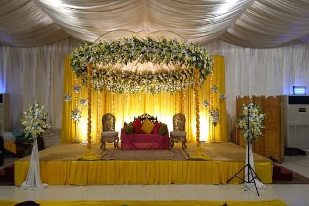 Elegant Floral Mandap with Traditional Yellow & White Wedding Backdrop