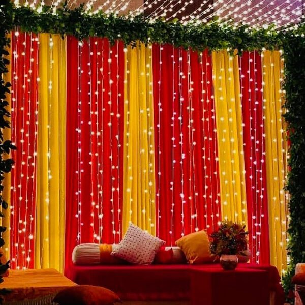 Elegant Wedding Backdrop with Red & Yellow Drapes & String Lights