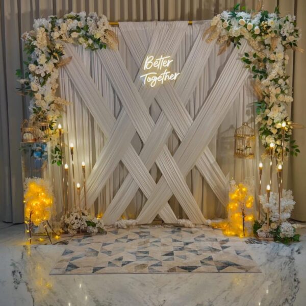 Elegant White Backdrop with Floral Details & Fairy Lights