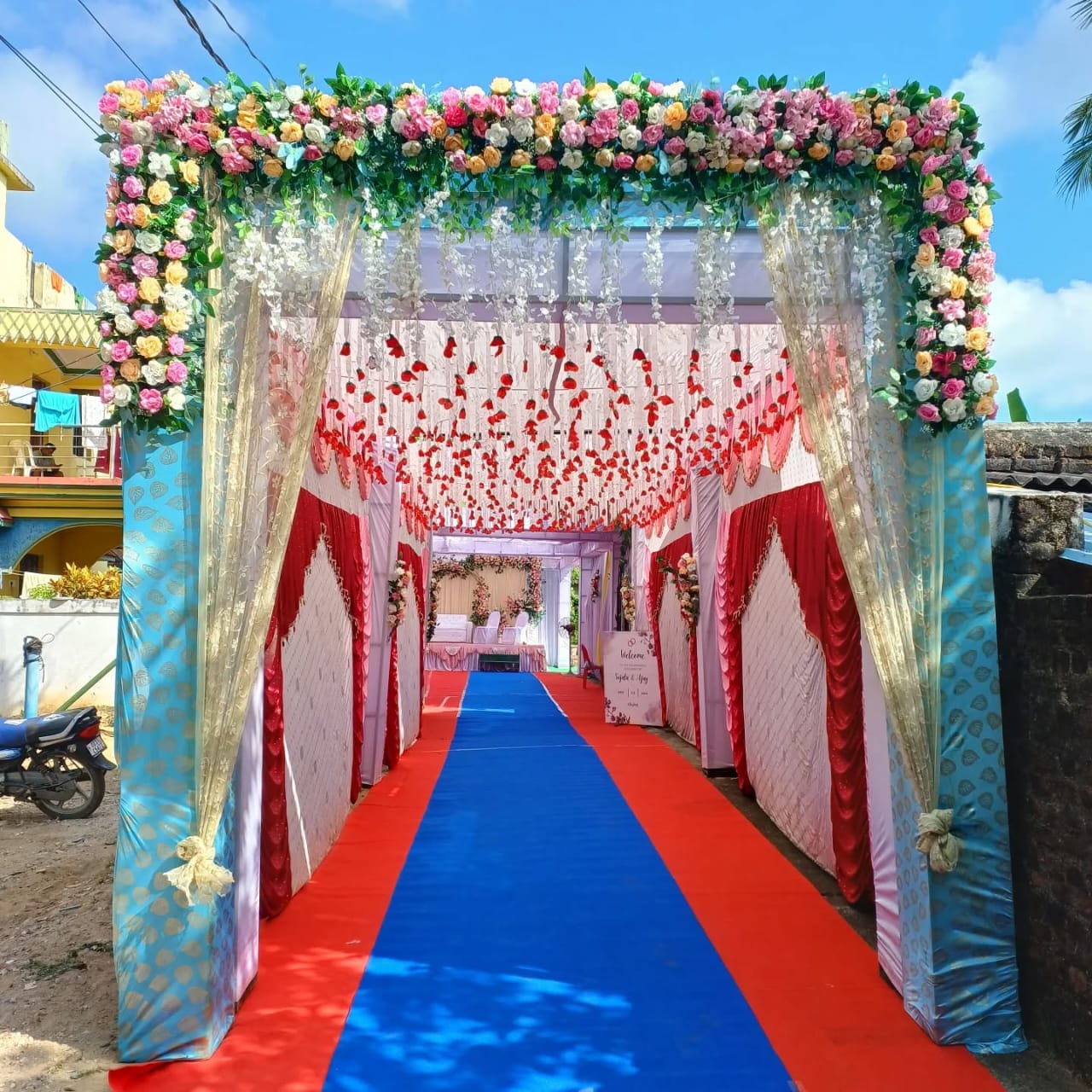 Luxurious Floral Entrance Tunnel with Red Carpet