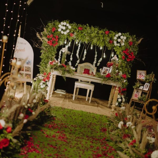 Greenery-Themed Photo Booth with Red & White Roses