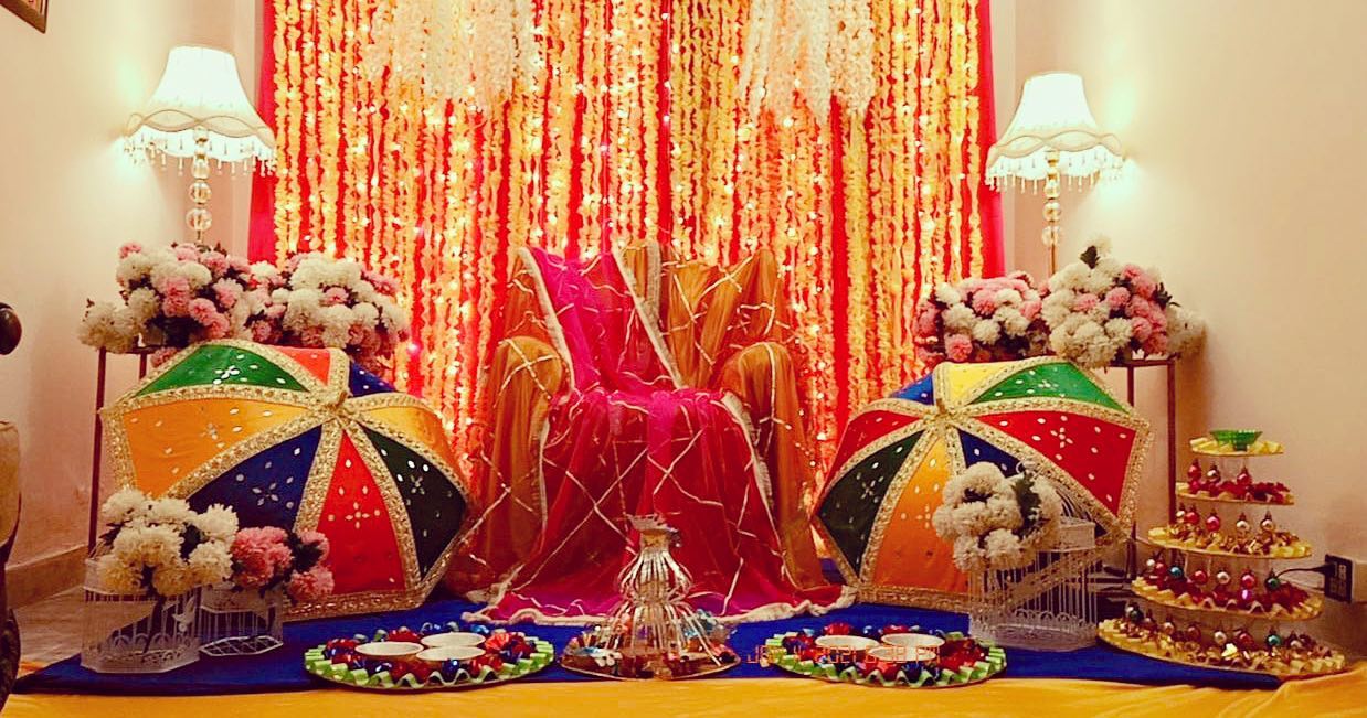 Vibrant Wedding Backdrop with Marigolds, Umbrellas & Traditional Decor